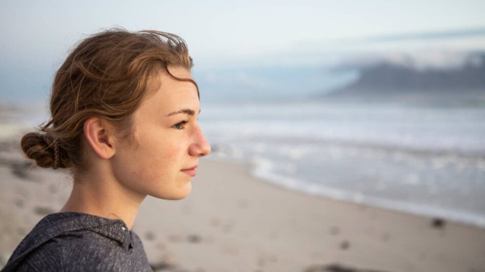 Person standing by the beach.