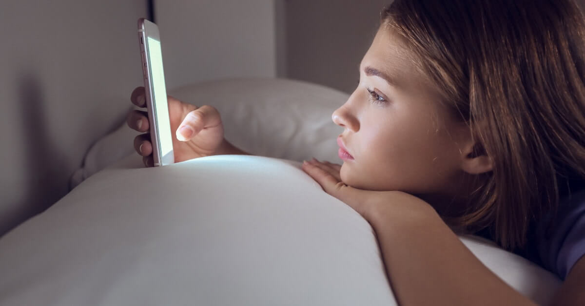 woman doomscrolling on phone. 